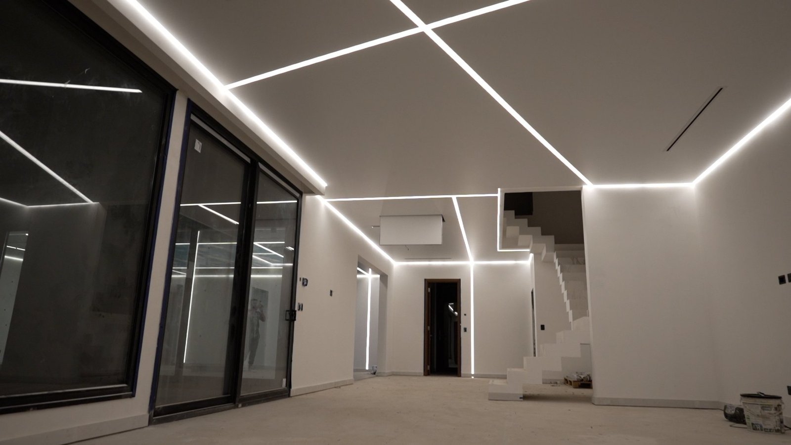 Cielorraso tensado con líneas LED instalado por Luminova Deco en living moderno